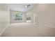 Large living room with carpet, fan and french doors to backyard at 1947 Broadleaf Ct, Windermere, FL 34786
