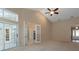 Spacious living room featuring high ceilings, a ceiling fan, and glass doors to the outside at 1947 Broadleaf Ct, Windermere, FL 34786