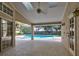Covered patio with ceiling fan offers a relaxing space overlooking the pool and backyard at 1947 Broadleaf Ct, Windermere, FL 34786
