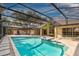 Large screened-in pool and spa with stone patio offering a relaxing outdoor oasis at 1947 Broadleaf Ct, Windermere, FL 34786