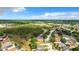 Expansive aerial view of a residential community with lush greenery and blue skies on a bright day at 2124 Fish Eagle St, Clermont, FL 34714