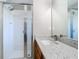 Bathroom featuring a sleek glass-enclosed shower, a modern vanity with light countertops, and contemporary fixtures at 2124 Fish Eagle St, Clermont, FL 34714