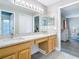 Luxurious bathroom featuring double sinks, a spacious vanity area, and ample lighting for comfortable grooming at 2124 Fish Eagle St, Clermont, FL 34714