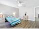 Comfortable bedroom with wood-look floors, ceiling fan, and versatile decor, offering a peaceful retreat at 2124 Fish Eagle St, Clermont, FL 34714