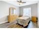 Bedroom featuring hardwood floors, ceiling fan, and large dresser at 2124 Fish Eagle St, Clermont, FL 34714