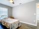 Bedroom has a neutral color scheme, window, and dark wood-look flooring at 2124 Fish Eagle St, Clermont, FL 34714