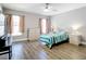 Serene bedroom with wood-look flooring, neutral walls, lots of natural light, and ample space for relaxation and rest at 2124 Fish Eagle St, Clermont, FL 34714