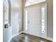 Inviting foyer with natural light, side-light windows and wood-look floors at 2124 Fish Eagle St, Clermont, FL 34714