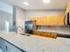 Well-appointed kitchen showcasing granite countertops, maple cabinets, and stainless appliances at 2124 Fish Eagle St, Clermont, FL 34714
