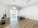Spacious living area boasting wood floors and sliding glass doors to a patio at 2124 Fish Eagle St, Clermont, FL 34714