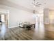 Bright living room with vaulted ceilings, wood floors, and neutral decor at 2124 Fish Eagle St, Clermont, FL 34714