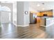 Spacious open floor plan featuring wood-look floors, a modern kitchen with stainless appliances, and ample natural light at 2124 Fish Eagle St, Clermont, FL 34714