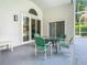 A covered patio features a table and chairs set, great for outdoor dining and relaxation at 2124 Fish Eagle St, Clermont, FL 34714