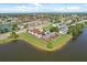An aerial scene capturing buildings, a lake, and the surrounding suburban landscape at 214 Majors Ln # C, Kissimmee, FL 34743