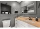 Gray toned bathroom featuring a modern vanity, mirror, and toilet at 214 Majors Ln # C, Kissimmee, FL 34743