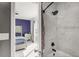 Primary bathroom featuring stone tile tub surround and view into bedroom at 214 Majors Ln # C, Kissimmee, FL 34743