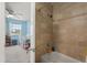 Bright bathroom off of the bedroom with light tan colored tile around a tub at 214 Majors Ln # C, Kissimmee, FL 34743