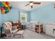 Charming baby bedroom with blue walls, glider chair, and lovely decorations at 214 Majors Ln # C, Kissimmee, FL 34743