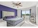 Primary bedroom featuring a ceiling fan, slider to balcony, and cat tree at 214 Majors Ln # C, Kissimmee, FL 34743