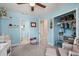 Light blue baby bedroom showing closet, shelves and adjoining bathroom at 214 Majors Ln # C, Kissimmee, FL 34743