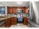 Updated kitchen with stainless steel appliances, granite countertops, and cherry wood cabinetry at 214 Majors Ln # C, Kissimmee, FL 34743