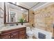 Well-maintained bathroom with tile surround, vanity, and updated fixtures at 2420 Kerridale St, Deltona, FL 32738
