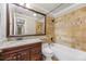 Well-maintained bathroom with tile surround, vanity, and updated fixtures at 2420 Kerridale St, Deltona, FL 32738