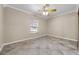 Spacious bedroom with tile flooring, a ceiling fan, and natural light from a window at 2420 Kerridale St, Deltona, FL 32738