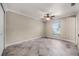 Simple bedroom with tile flooring, a ceiling fan, and natural light from the window at 2420 Kerridale St, Deltona, FL 32738