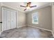 Simple bedroom with tile flooring, a ceiling fan, and natural light from the window at 2420 Kerridale St, Deltona, FL 32738