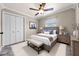 Comfortable bedroom featuring neutral decor, a ceiling fan, and ample closet space at 2420 Kerridale St, Deltona, FL 32738