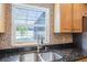 Kitchen sink featuring stone backsplash and view of pool at 2420 Kerridale St, Deltona, FL 32738