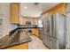 Kitchen with stone backsplash, granite counters, and stainless steel refrigerator at 2420 Kerridale St, Deltona, FL 32738