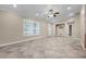 Spacious living room boasts tile flooring, crown molding, and ample natural light at 2420 Kerridale St, Deltona, FL 32738