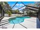 Relaxing screened pool with unique tile and comfortable seating area, perfect for entertaining guests at 2420 Kerridale St, Deltona, FL 32738