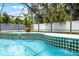 Close up of the in-ground pool featuring beautiful tiling around the edge and clear blue water at 2420 Kerridale St, Deltona, FL 32738