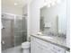 Well-lit bathroom features a glass enclosed shower and granite vanity at 2439 Dubai St, Kissimmee, FL 34747