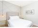 Bright bedroom features a modern design with a geometric accent wall and stylish gold lighting fixtures at 2439 Dubai St, Kissimmee, FL 34747