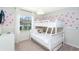 White bunk bed featuring Mickey Mouse wallpaper and natural light at 2439 Dubai St, Kissimmee, FL 34747