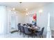 Elegant dining room featuring a modern chandelier, stylish decor, and seating for eight guests at 2439 Dubai St, Kissimmee, FL 34747