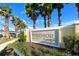 Entrance sign that reads 'Windsor at Westside', landscaped with palm trees, greenery and a sidewalk at 2439 Dubai St, Kissimmee, FL 34747