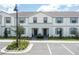 Charming townhome featuring a light exterior, blue shutters and well-maintained landscaping at 2439 Dubai St, Kissimmee, FL 34747