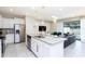 Open-concept kitchen with stainless steel appliances and granite countertops, seamlessly connected to the living area at 2439 Dubai St, Kissimmee, FL 34747