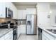 Well-equipped kitchen with stainless steel refrigerator, sleek appliances, and stylish backsplash at 2439 Dubai St, Kissimmee, FL 34747