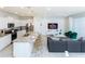 Open-concept living area featuring a modern kitchen and seating area with a sleek entertainment center at 2439 Dubai St, Kissimmee, FL 34747