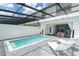 Covered pool and lounge area with outdoor dining and beautiful views of the backyard at 2439 Dubai St, Kissimmee, FL 34747