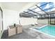 Covered pool with lounge chairs and a dining set for outdoor entertaining at 2439 Dubai St, Kissimmee, FL 34747