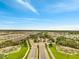 Wide aerial shot of the community entrance, revealing the water features, landscaping, and road layout at 2479 Pine Preserve Ct, St Cloud, FL 34771