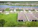 Aerial view of home with a screened in porch, landscaping and a lake community at 2479 Pine Preserve Ct, St Cloud, FL 34771
