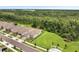 An aerial view shows a neighborhood community lined with trees and green space at 2479 Pine Preserve Ct, St Cloud, FL 34771